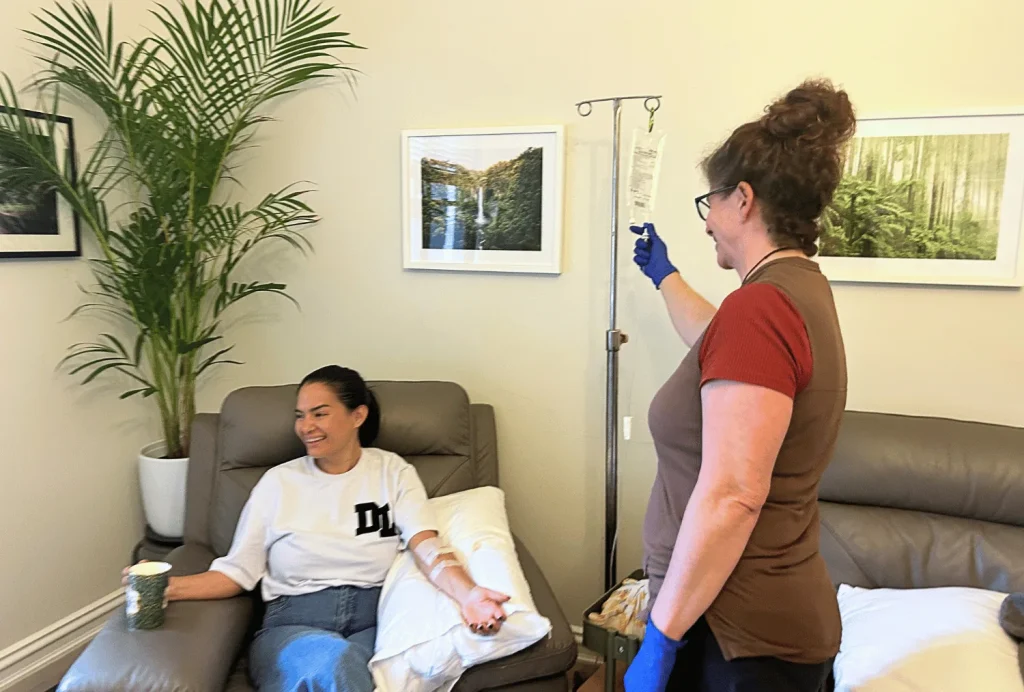 Patient receiving IV therapy with nurse Ali Evans